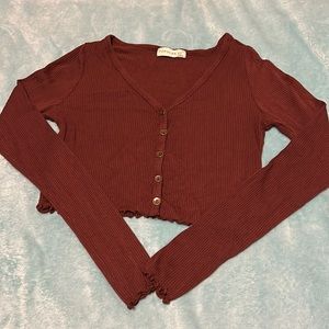 A Brown button up cropped top